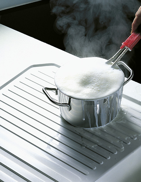 An overcooked pot on a BLANCO stainless steel sink