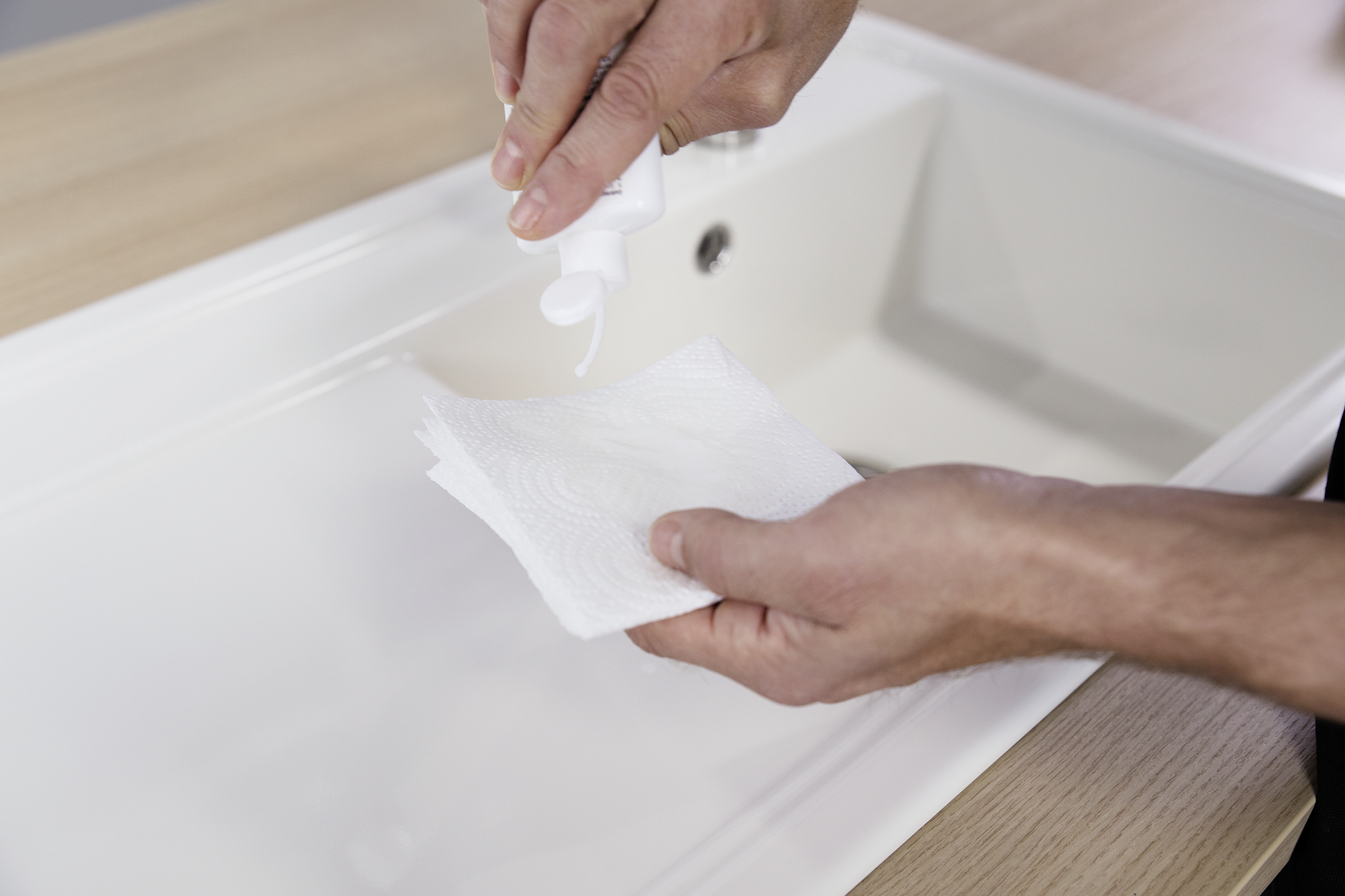 Shake the PuraPlus liquid and squeeze a little of the cleaning fluid onto a paper towel.